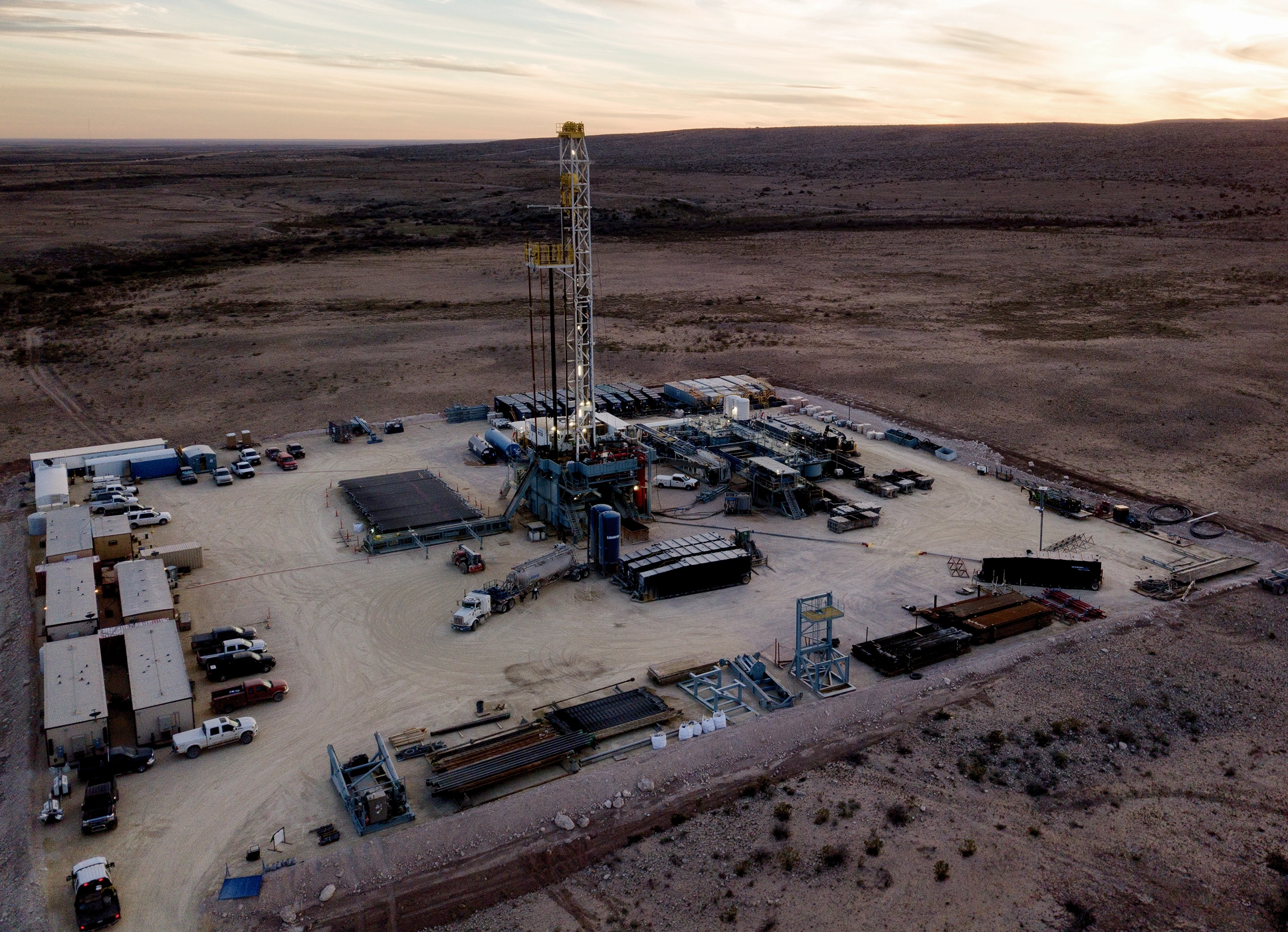 Industrial site with drilling equipment at dusk